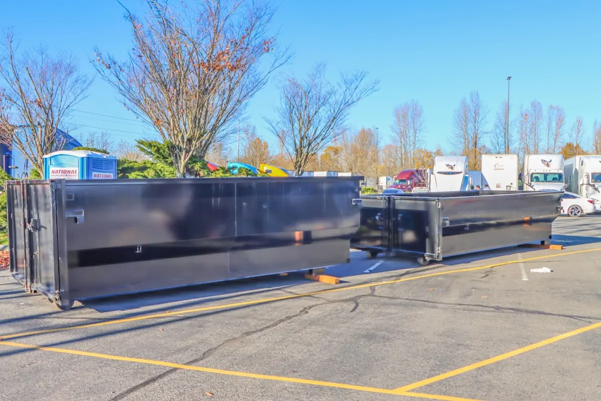 Professional dumpster rental service with roll-off container on residential driveway in Heber